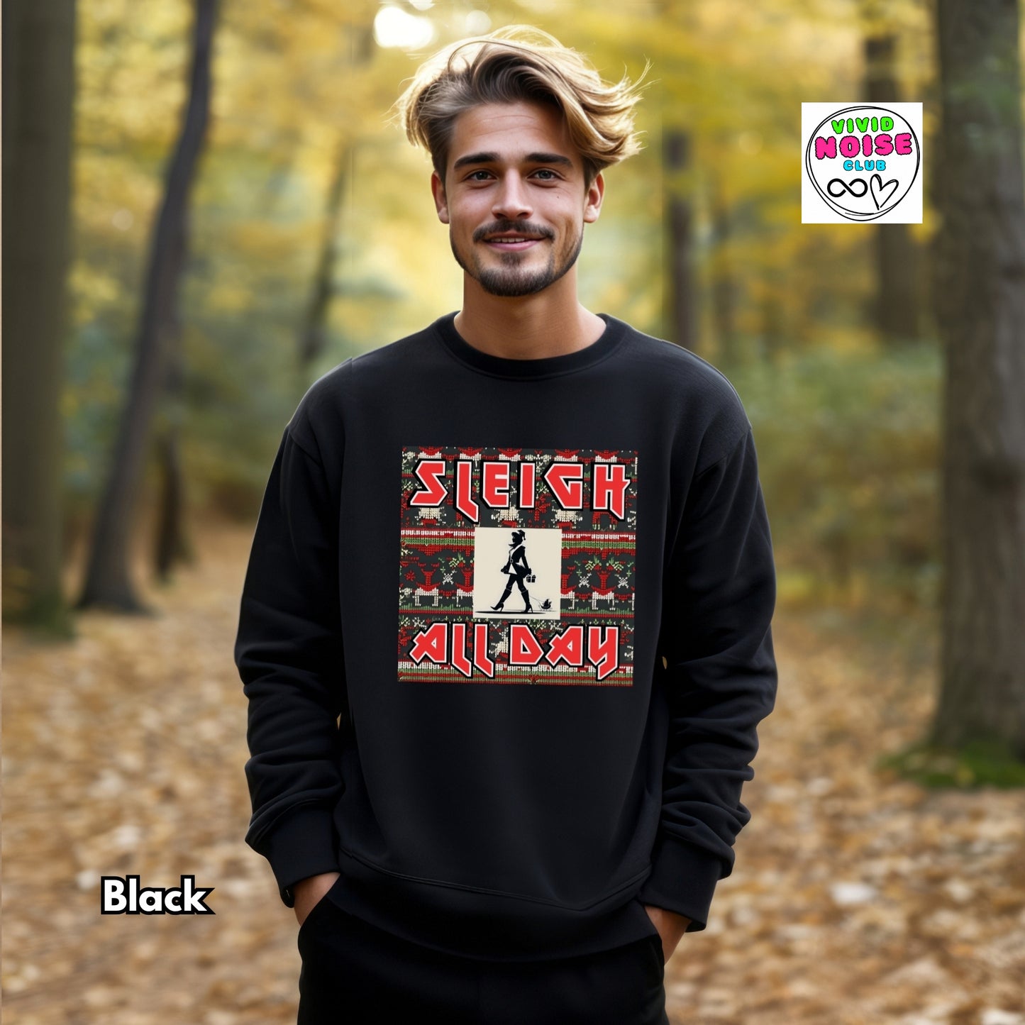 Man wearing a black sweatshirt with 'Sleigh All Day' design in a forest setting