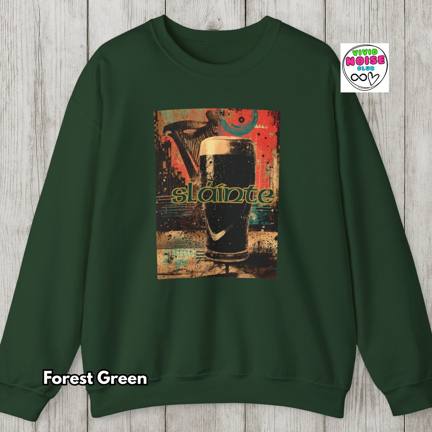 Green sweatshirt with a graphic design on a wooden surface