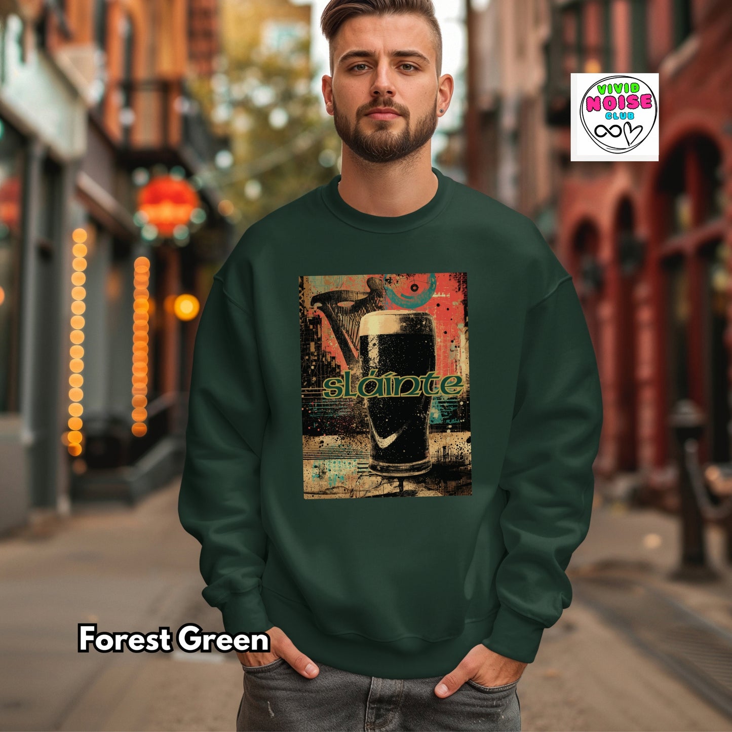 Man wearing a forest green sweatshirt with a graphic design on a city street.