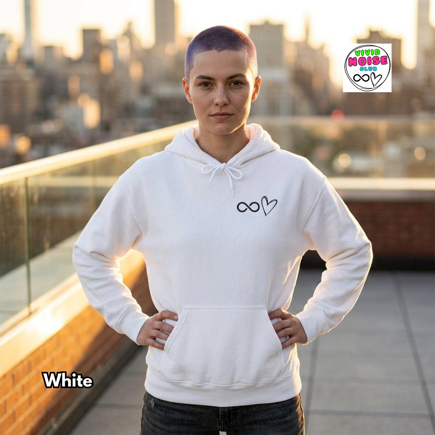 Person wearing a white hoodie with a design on a rooftop with a cityscape background