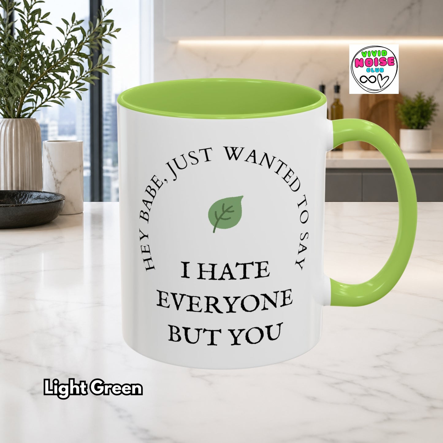 Mug with text and light green interior and handle on a kitchen counter