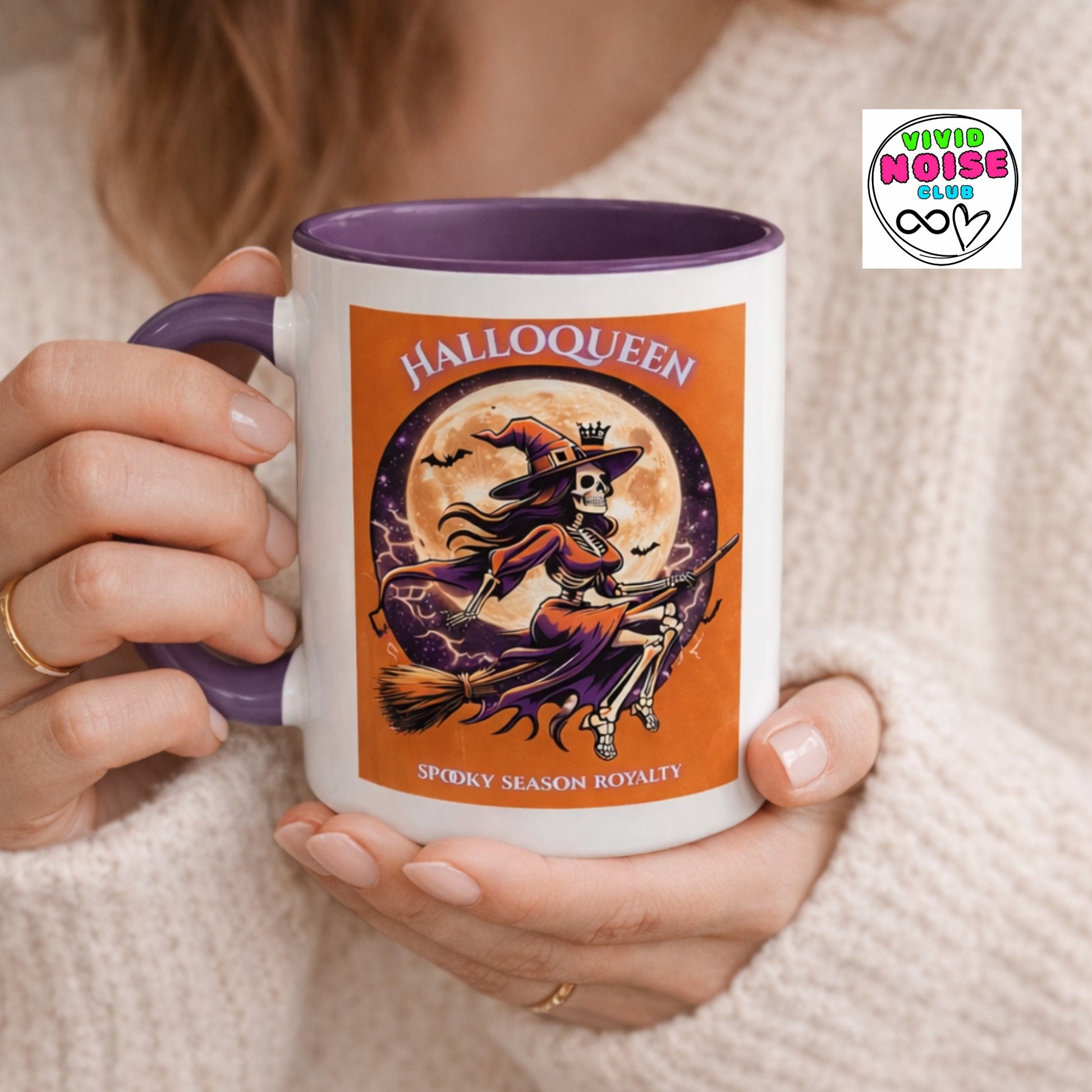 Person holding a mug with 'Halloqueen' design featuring a witch and moon, branded with Vivid Noise Club.
