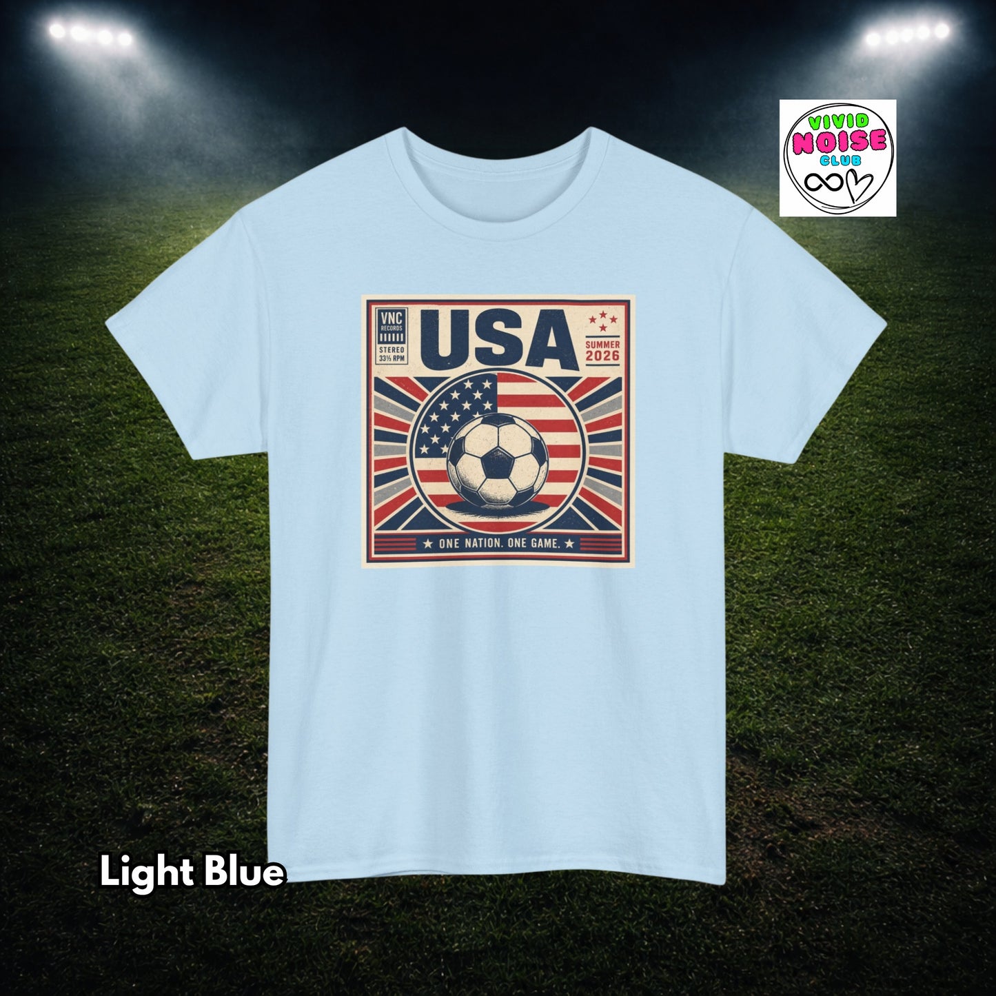 Light blue t-shirt with USA soccer design on a dark green field background
