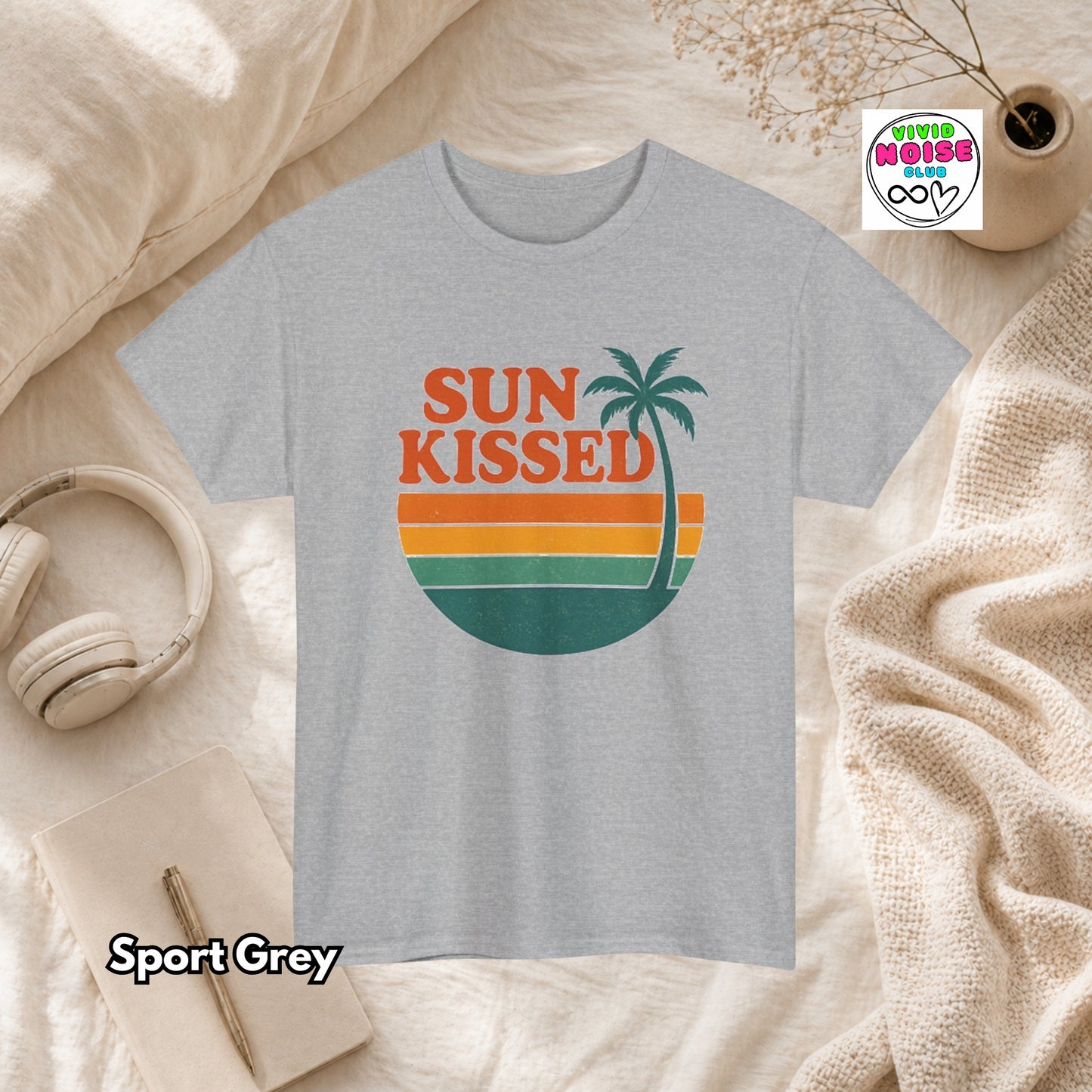 Sport Grey t-shirt with 'Sun Kissed' design on a textured surface with accessories.