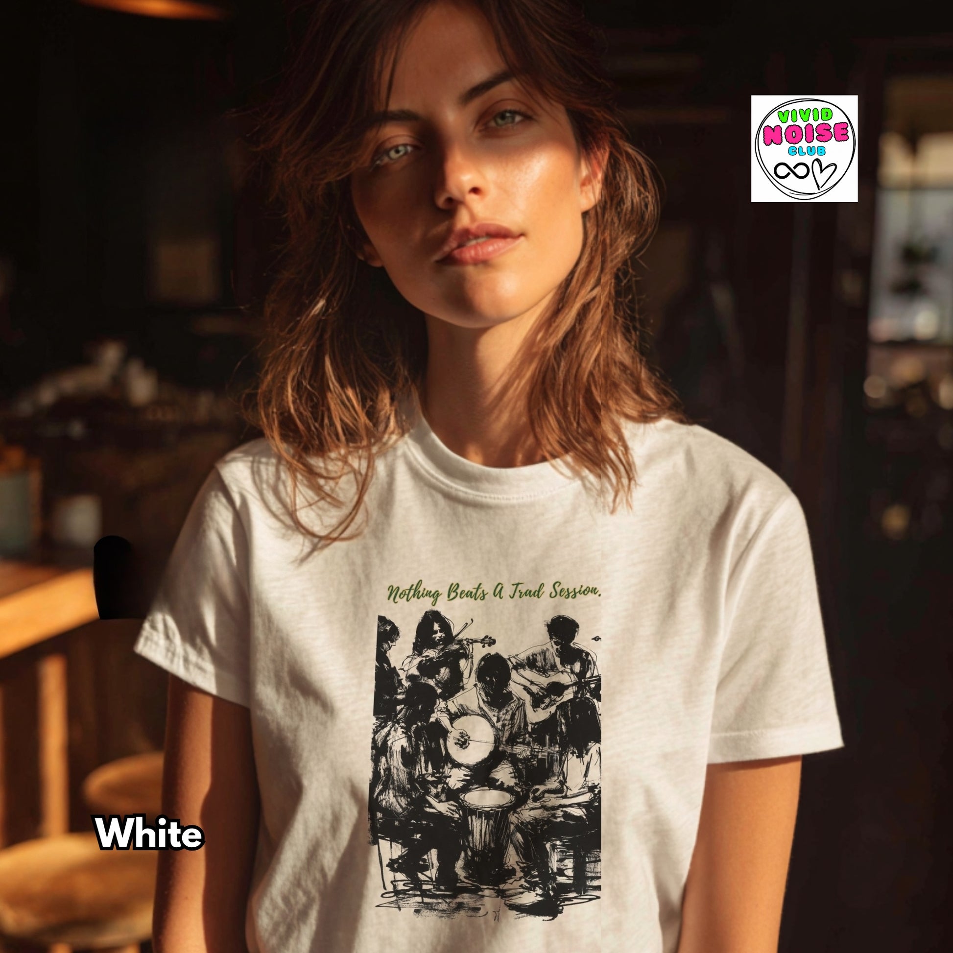 Woman in a warm-toned setting wearing a white t-shirt with a Nothing Beats A Trad Session graphic featuring musicians gathered in a traditional Irish music session, celebrating live folk music, community and pub culture. 