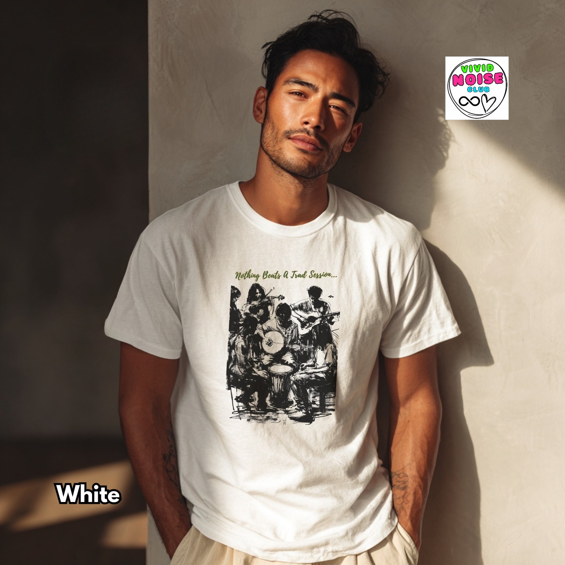 Man standing against a wall wearing a white t-shirt with a Nothing Beats A Trad Session graphic featuring musicians gathered in a traditional Irish music session, celebrating live folk music, community and pub culture.