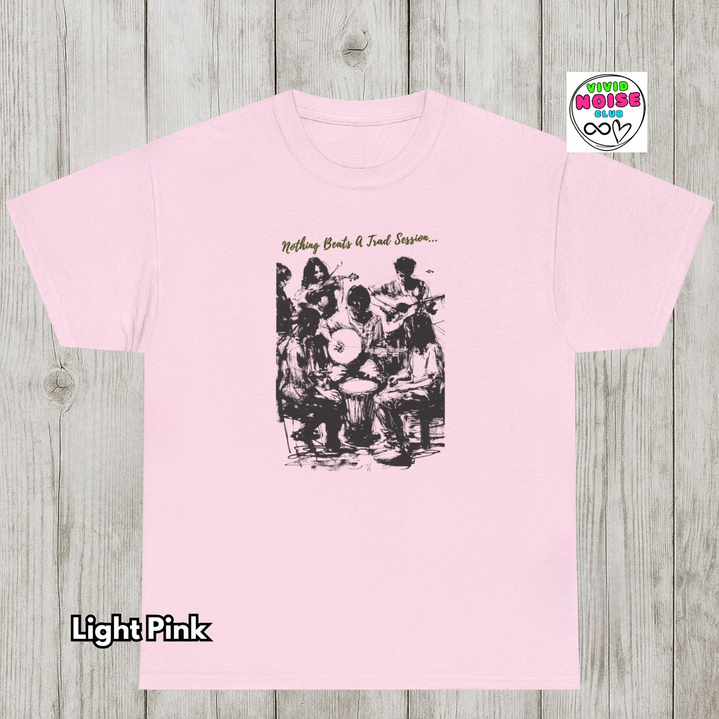 Light pink t-shirt with Nothing Beats A Trad Session graphic featuring musicians gathered in a traditional Irish music session, celebrating live folk music, community and pub culture.