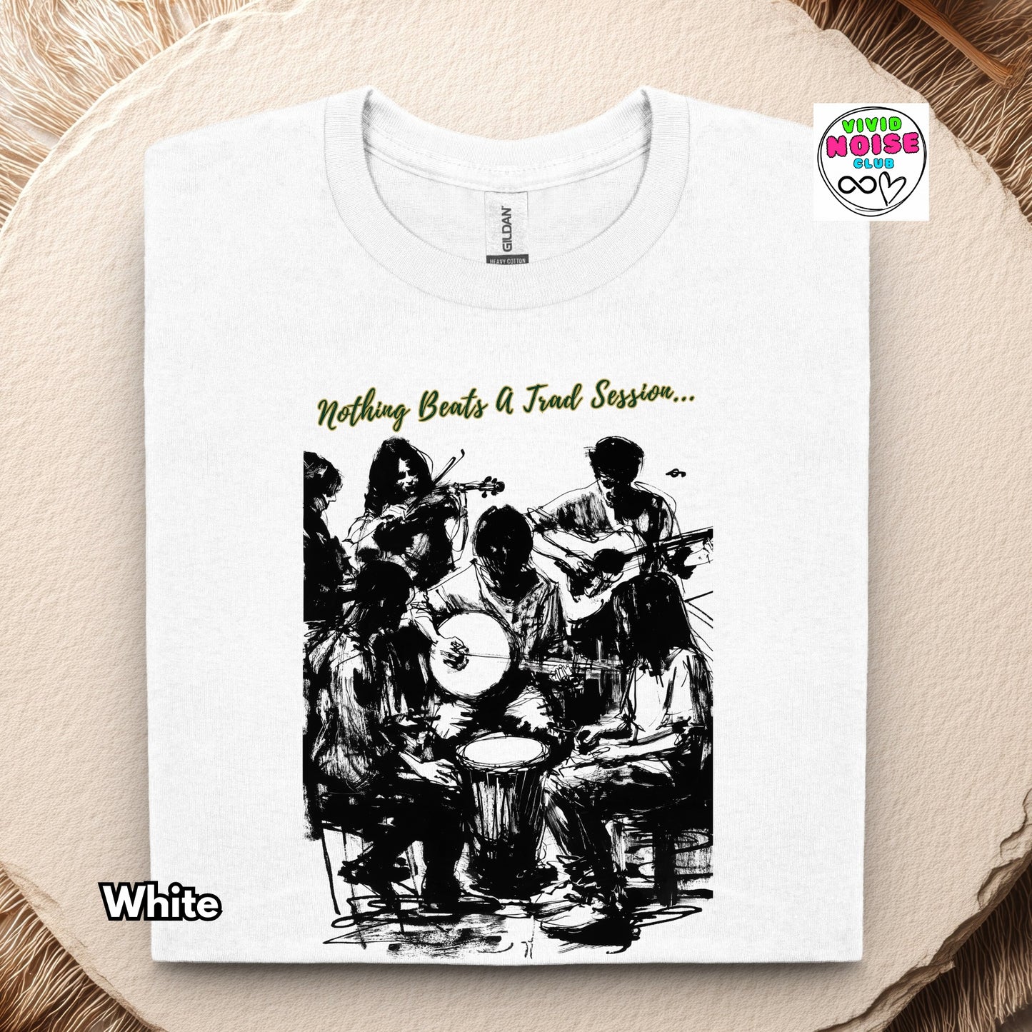 White t-shirt with black and white illustration of people playing music and text 'Nothing Beats A Trad Session' on a beige background.