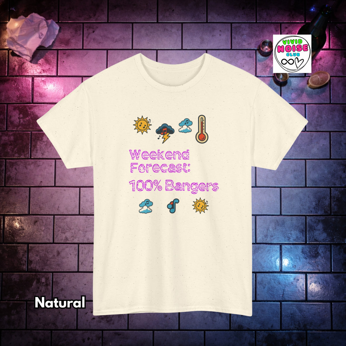 A cream-colored short-sleeve t-shirt with a weather-themed graphic on the front reading 'Weekend Forecast: 100% Bangers' in pink, surrounded by small weather icons. The shirt is displayed against a dark brick wall background with purple and blue lighting, with 'Natural' text in the bottom-left corner and a 'Vivid Noise Club' logo in the top-right corner.