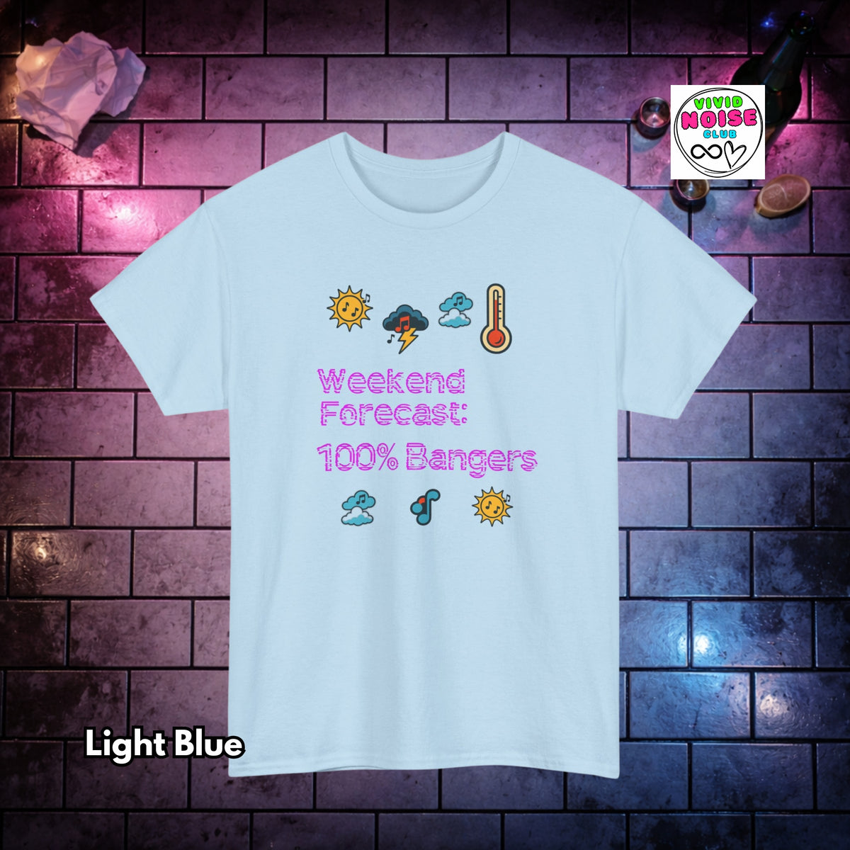 A light blue graphic t-shirt displayed against a dark brick wall background with purple lighting. The t-shirt features a cartoon weather graphic and the text 'Weekend Forecast: 100% Bangers'.