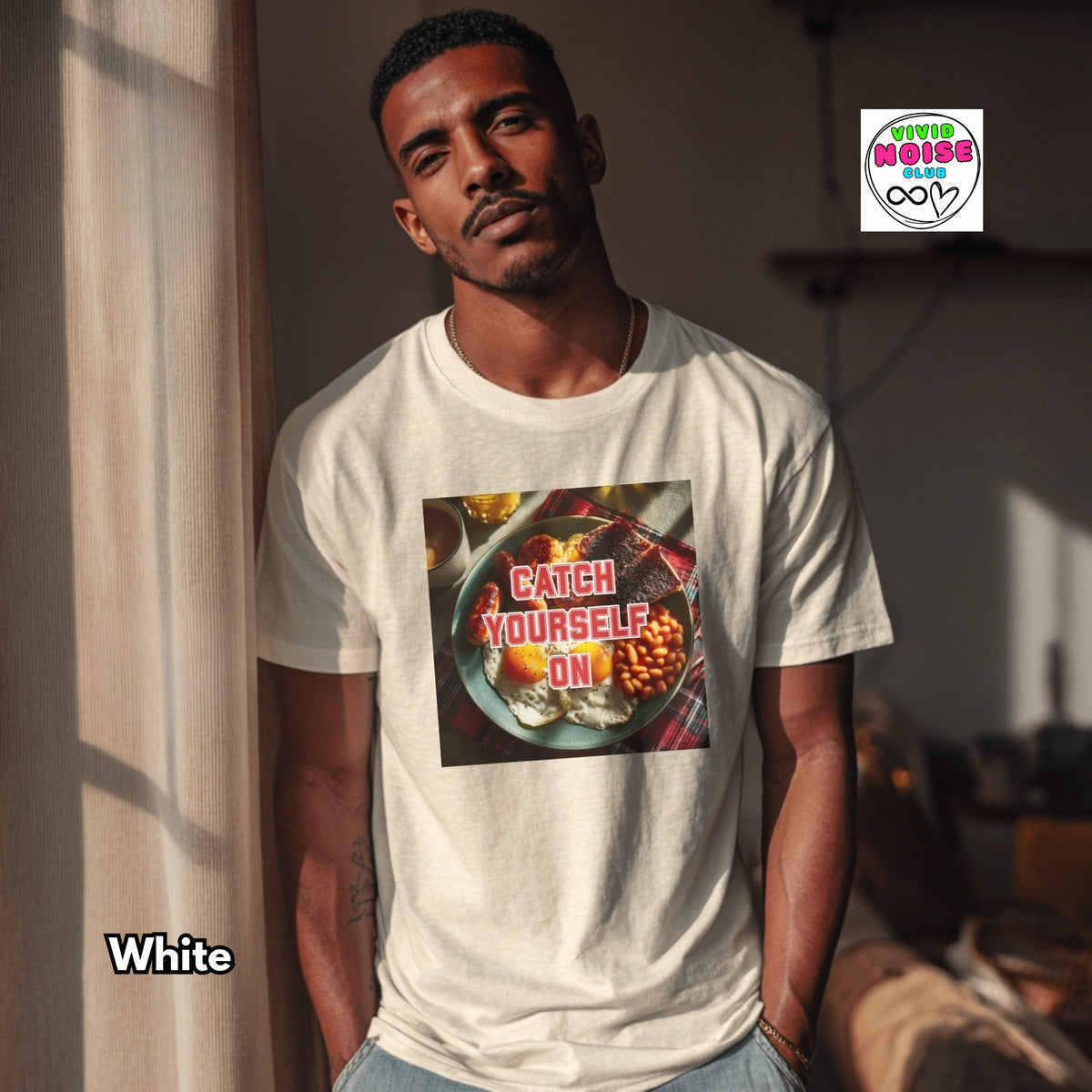 A man wearing a white graphic t-shirt with a food-themed print that reads 'CATCH YOURSELF. ON.