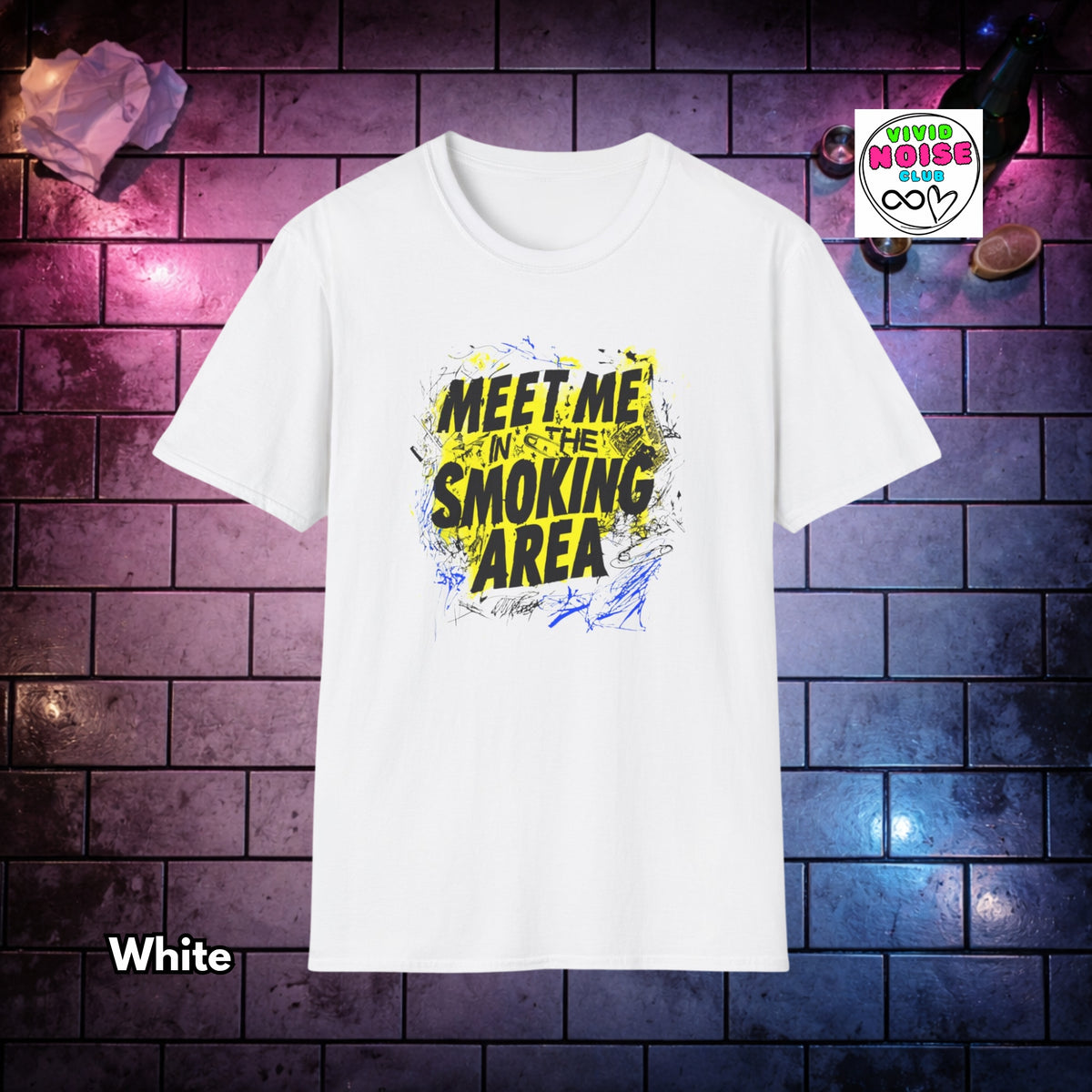 A white short-sleeve t-shirt with a bold graphic on the chest reading 'MEET ME IN THE SMOKING AREA' in black and yellow with blue paint splatters. The shirt is displayed against a dark brick wall background with purple and blue lighting, with a 'Vivid Noise Club' logo in the top right and the word 'White' in the bottom left.