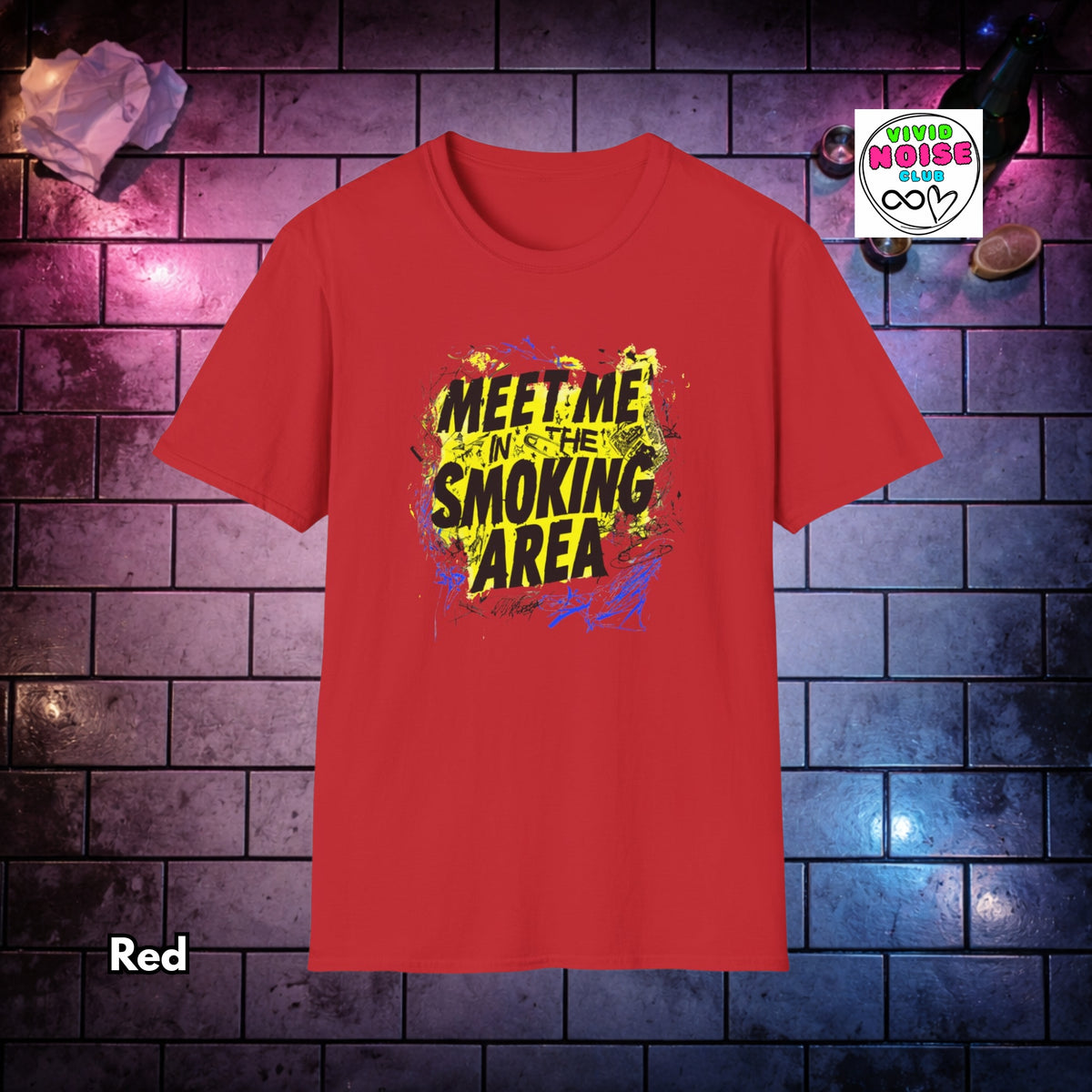 A red short-sleeve t-shirt with a colorful graphic print reading 'MEET ME IN THE SMOKING AREA' in black text over yellow, blue, and purple paint splatter. The shirt is displayed against a dark brick wall background with purple and blue lighting, with a 'Vivid Noise Club' sticker overlay in the top right and a 'Red' color label overlay in the bottom left.