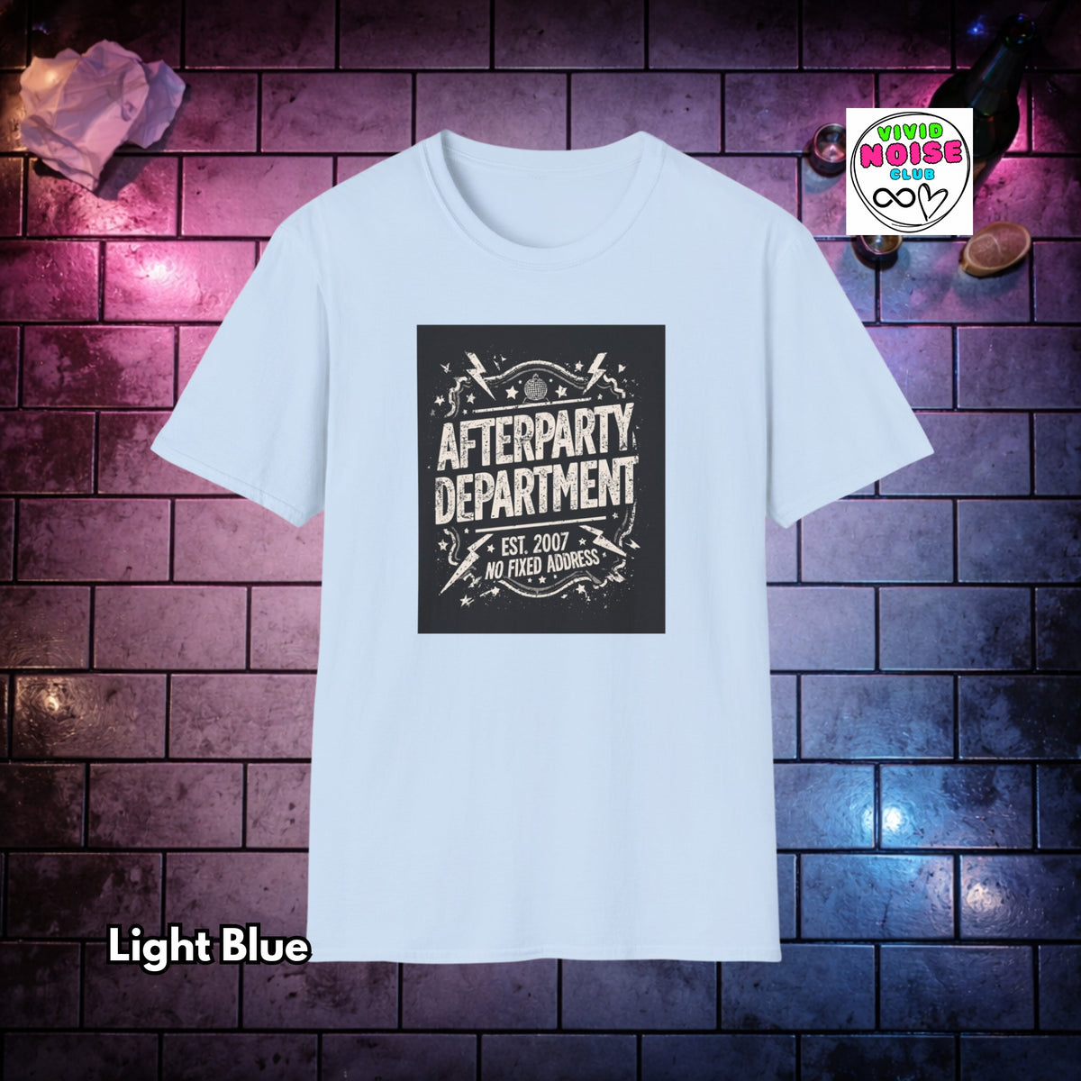 A light blue short-sleeve t-shirt with a black rectangular graphic on the chest that reads 'AFTERPARTY DEPARTMENT EST. 2007 NO FIXED ADDRESS' in distressed white lettering.