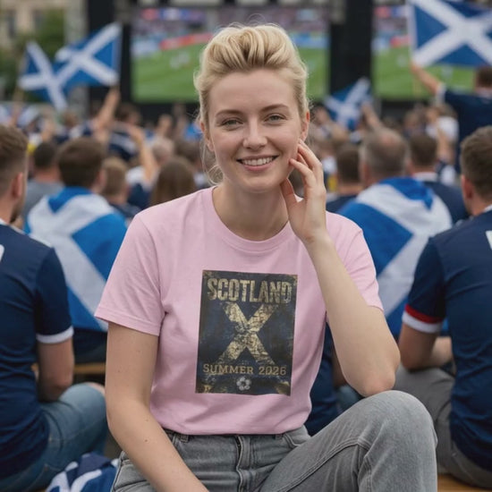 Video showing the Scotland Summer 2026 football t-shirt on a model in a match day crowd setting, featuring a vintage blue and white supporter graphic.