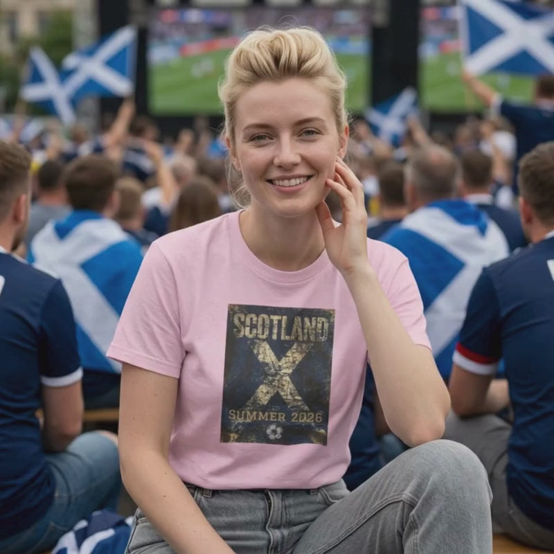 Video showing the Scotland Summer 2026 football t-shirt on a model in a match day crowd setting, featuring a vintage blue and white supporter graphic.