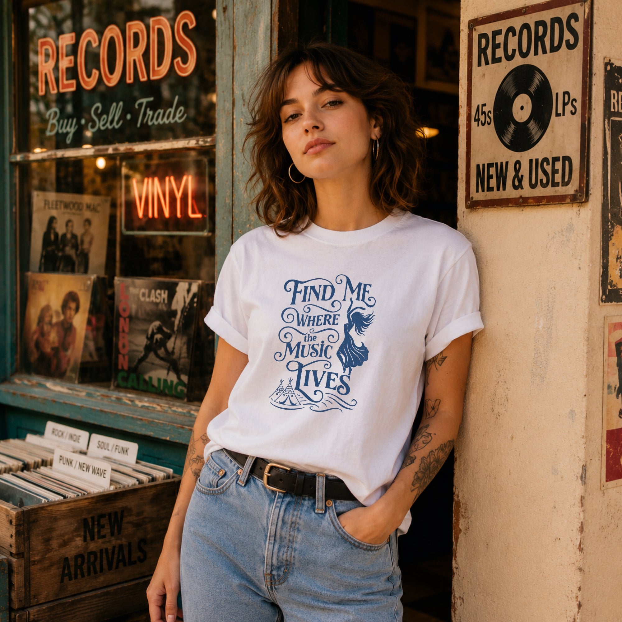 Video showing the Find Me Where The Music Lives t-shirt on a model outside a vintage record shop, styled as a boho music festival tee.
