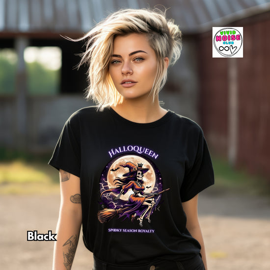 Video of a graphic t-shirt. The shirt features a colorful illustration of a witch riding a broomstick across a full moon with the text 'HALLOQUEEN' and 'SPOOKY SEASON ROYALTY'.
