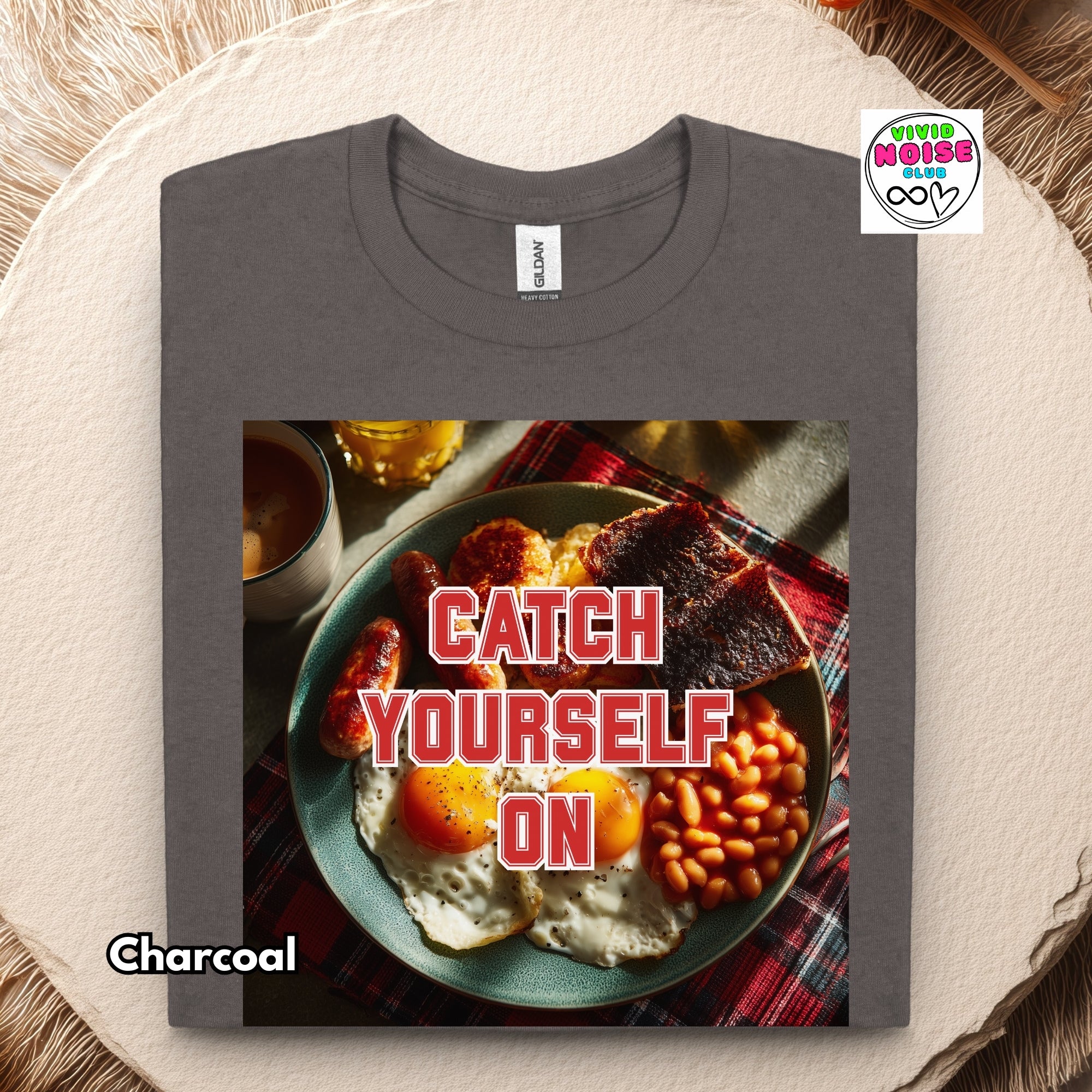 Video showing a t-shirt which features a square print of a bowl with eggs and beans and the words 'CATCH YOURSELF ON' in red.